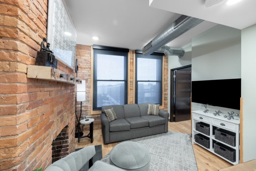 Duluth Rental Suite 201 - Living area with windows and fireplace