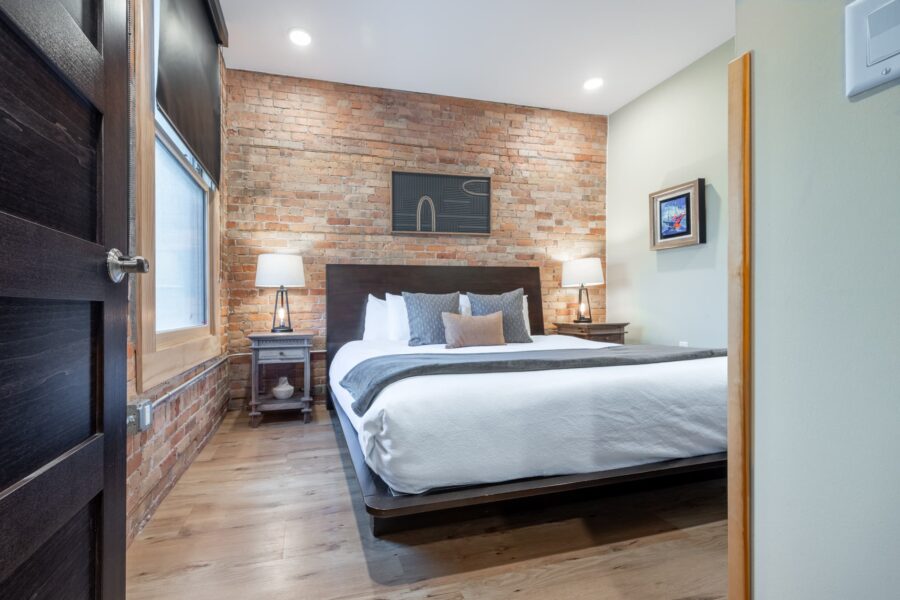 Duluth Rental Suite 201 - exposed brick in bedroom
