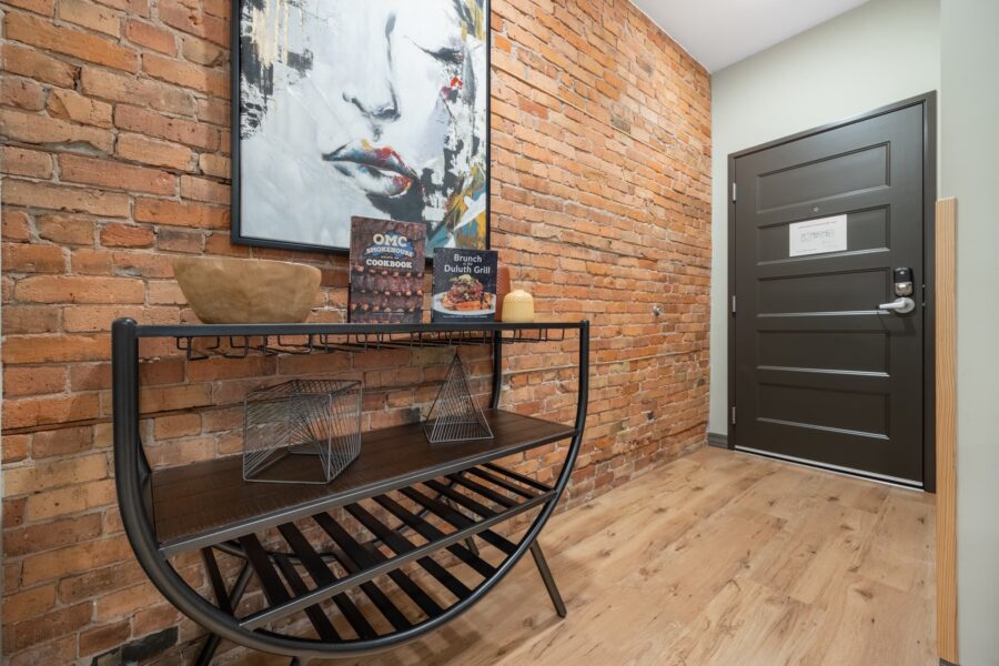 Duluth Rental Suite 203 - shelving, artwork and exposed brick with hardwood floors