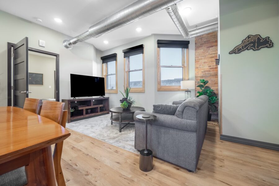 Duluth Rental Suite 203 - Living area with three large windows and view, Lake Superior artwork