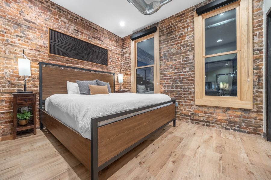 Duluth Rental Suite 303 - Plush king bedroom with exposed brick, hardwood floors and views
